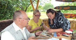 V.Mačiekus su ekspedicijos dalyvėmis apžiūrinėjo senas fotografijas. D.Zibolienės nuotr.