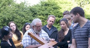 Drožėjas  V.Zakarka (centre) misijos dalyvius mokė montuoti kryžių. N.Byčkovskio nuotr.